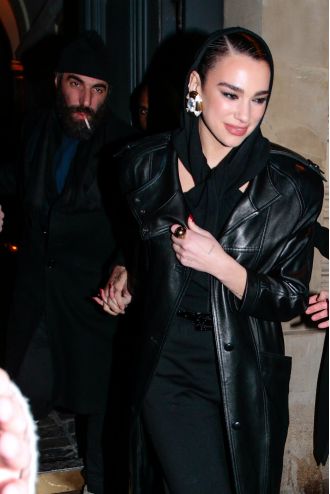 Dua Lipa and her boyfriend Romain Gavras were seen holding hands as they left the Saint Laurent fashion show in Paris.