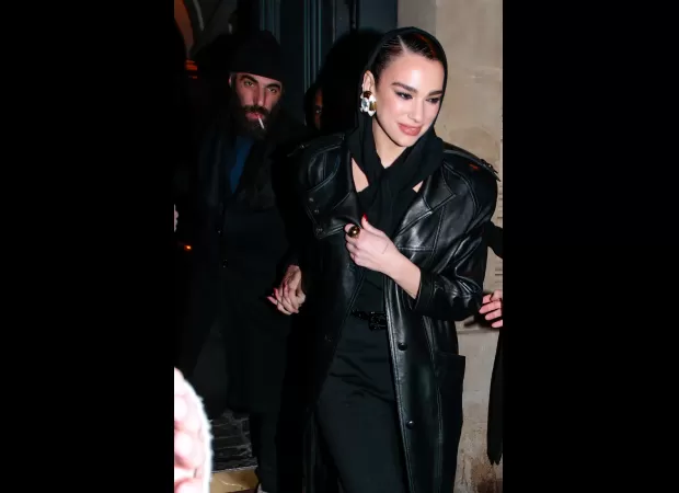 Dua Lipa and her boyfriend Romain Gavras were seen holding hands as they left the Saint Laurent fashion show in Paris.
