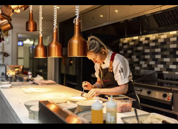 Experience a unique dining experience with a seat at the chef's table at the Commons Club Edinburgh.