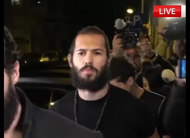 Andrew Tate posts video of himself walking around shirtless, smoking a cigar.