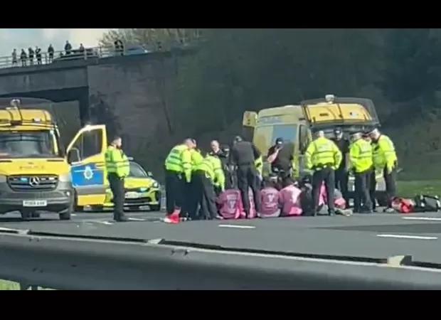 Protesters blocked M57 traffic by sitting in the middle of the road to draw attention to the Grand National.
