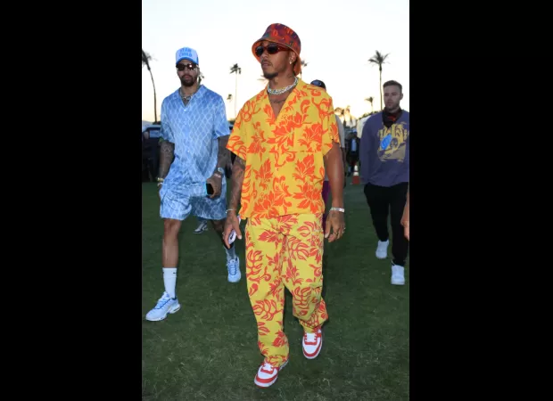 Lewis Hamilton stands out in a bright yellow two piece at Coachella 2023.