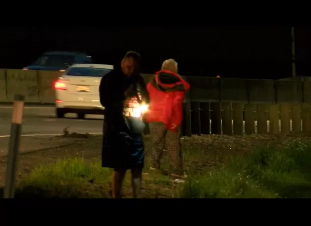 Man throws $200,000 out car window to spread blessings, causing drivers to scramble for cash.