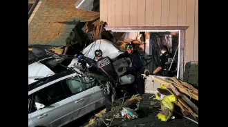 Car veers off road and smashes through upper floor of house.