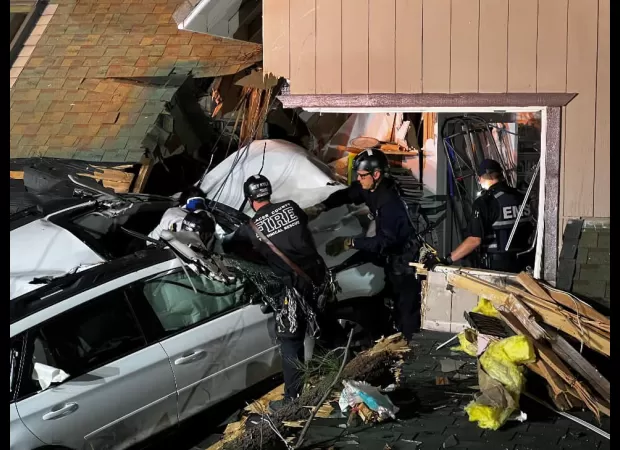 Car veers off road and smashes through upper floor of house.