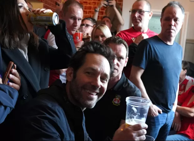 Paul Rudd joins football fans in a Wrexham pub for beers, singing, and a good time.