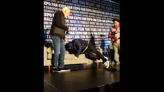 Michael J Fox falls onstage during Back to the Future event, showing the effects of Parkinson's Disease.