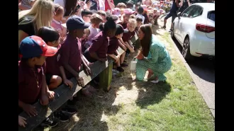 Kate Middleton wears summery leopard-print midi dress for visit to Nuneaton children's centre.