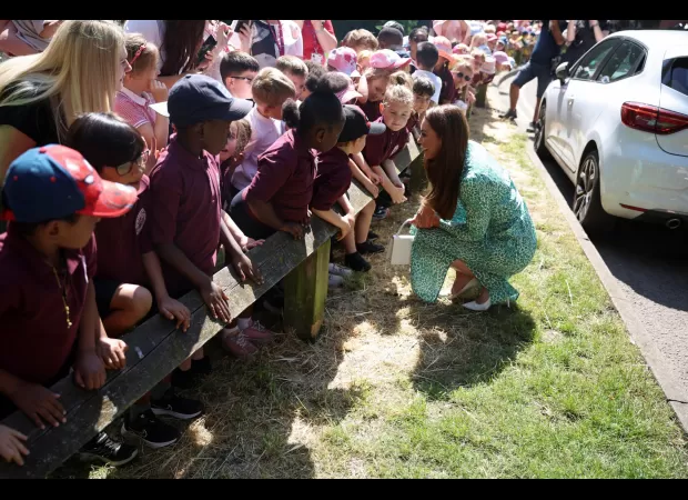 Kate Middleton wears summery leopard-print midi dress for visit to Nuneaton children's centre.