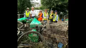Pickers recover 100th trolley from Thames after two years of river cleanup.