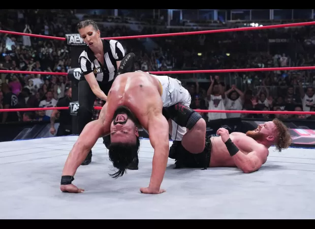 Charlotte Flair celebrates her husband Andrade's victory after a romantic gesture in his match.