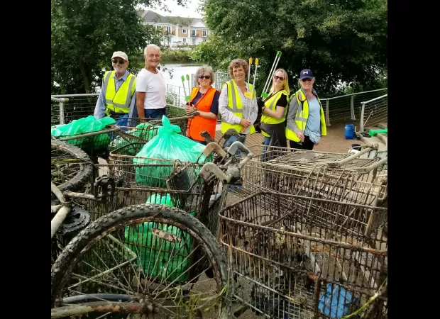 Pickers recover 100th trolley from Thames after two years of river cleanup.