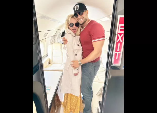 Britney and Sam cuddle as she requests a drink on a private jet.