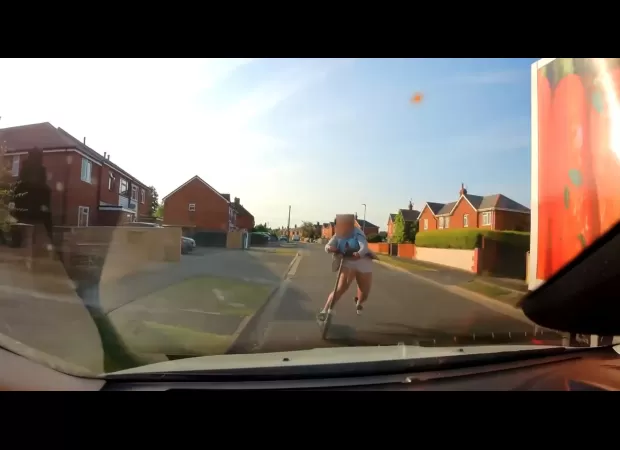 Driver nearly hit child on scooter in the street.