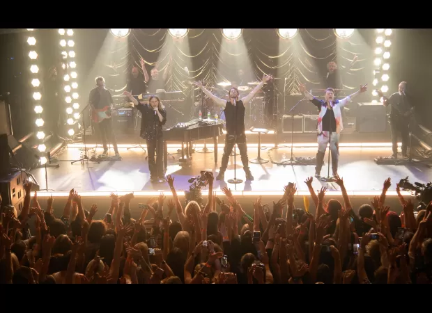 Fans show support for Howard Donald after he was removed from Pride festival line-up, holding up signs saying 