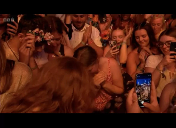 BBC cameras record a romantic proposal during Sir Elton John’s duet with Brandon Flowers, thrilling viewers.