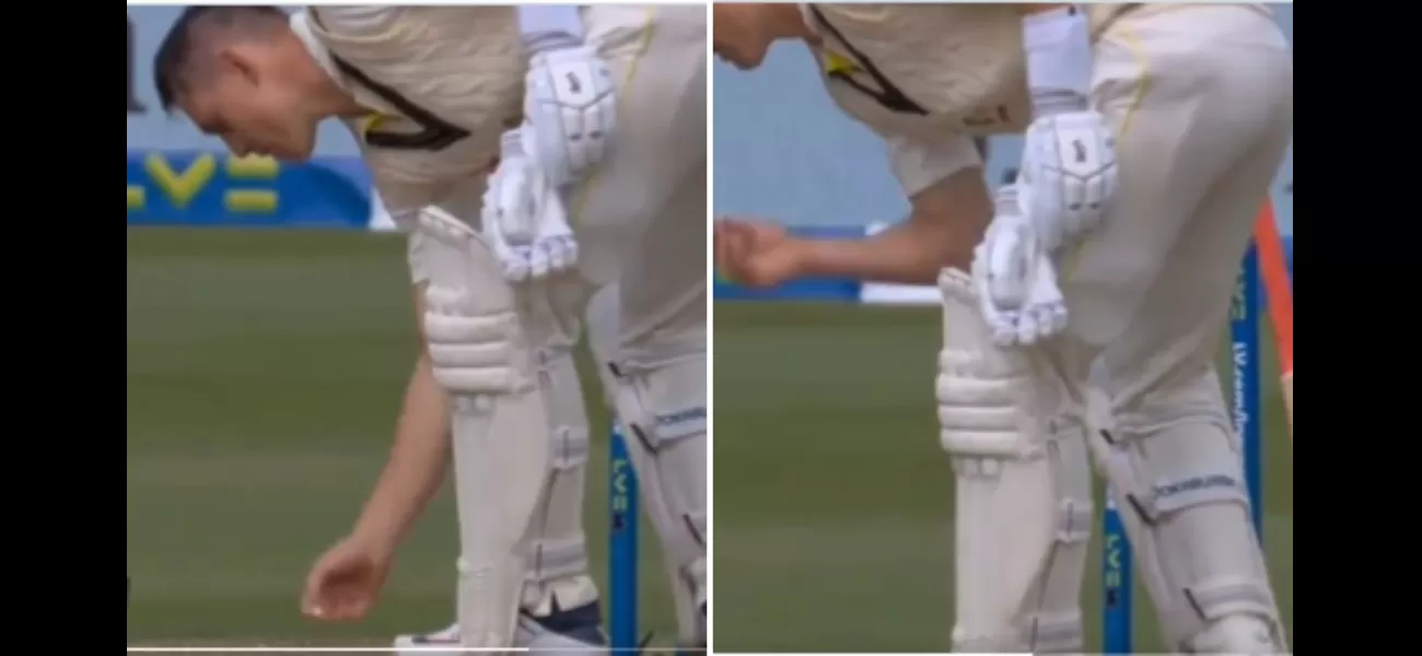 Marnus Labuschagne picks up chewing gum from the ground and puts it back in his mouth.