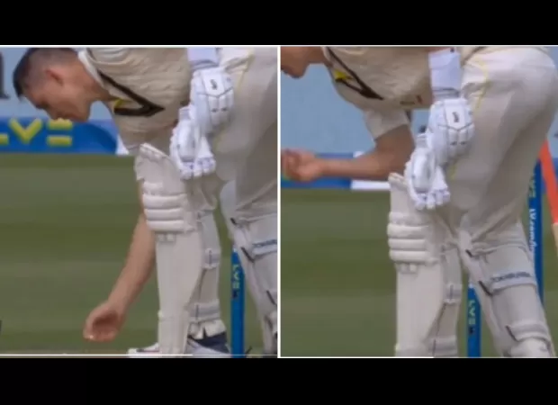 Marnus Labuschagne picks up chewing gum from the ground and puts it back in his mouth.