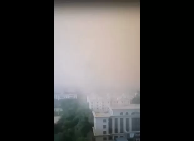 A city is consumed by a sandstorm with towering dust clouds reaching 300ft.