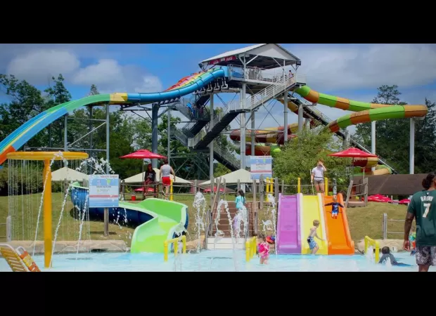 Boy, 5, soars off water slide at amusement park for thrilling ride.