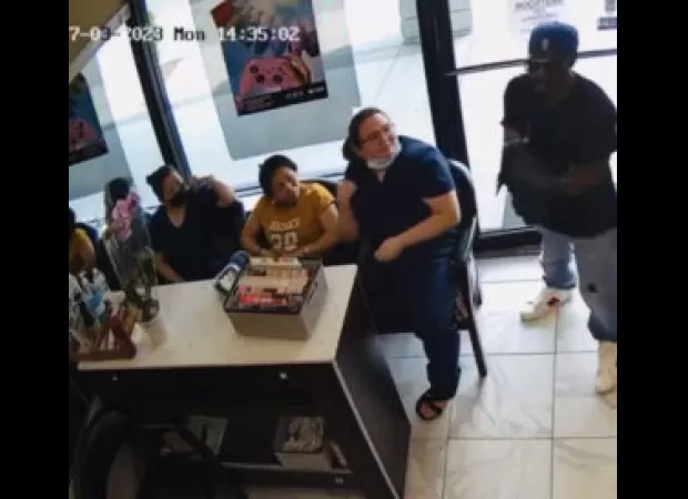 Robber thwarted by courageous customers who refused to be intimidated.