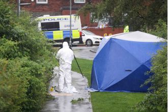 A woman in her 40s was found dead on a footpath close to a primary school.