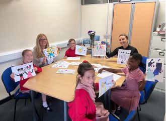 School children show support by making art for refugee centre after their murals were painted over.