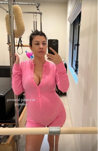 Kourtney Kardashian wears a stylish Barbie pink outfit for her pregnancy workout.
