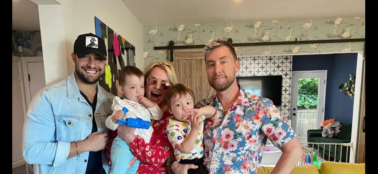 Britney meets Lance's babies and cuddles them in a joyous snap.