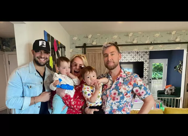 Britney meets Lance's babies and cuddles them in a joyous snap.