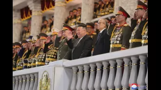 Kim & Putin's defence chief laugh as nukes roll by at military parade.