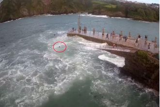 Woman is pulled out to sea by a powerful wave.