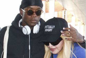Madonna, 64, arrived at an airport with her son David, 17, after recently spending time in intensive care.