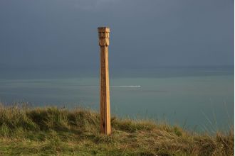 A mysterious totem pole with the name of a thunder god has been found along a coastal path.
