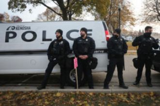 Officers in Kenosha seen using excessive force on an innocent Black man holding a baby in his arms.