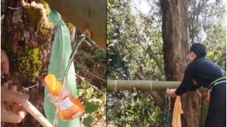 Minister Temjen Along shows how villages use bamboo to make innovative wash basins.