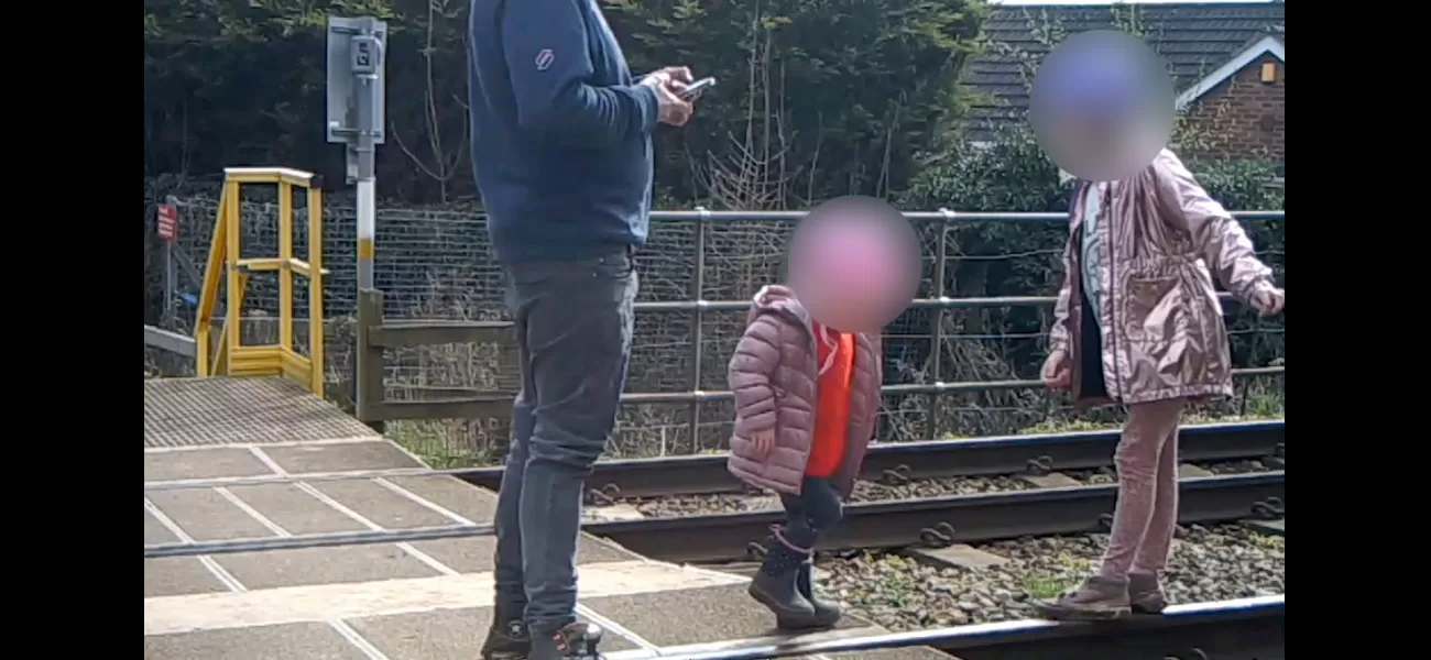 Dad seen on security footage allowing two kids to play on active train tracks.