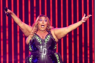Lizzo says she's staying positive despite the sexual harassment lawsuit.