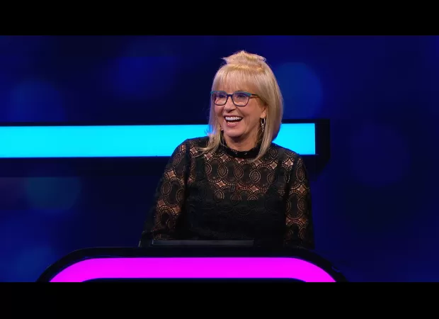 TV host returns to game show after 9 years away, following partner's death.