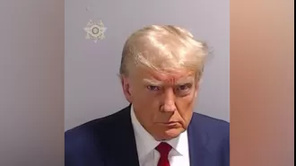 Donald Trump scowling as he stares into the camera for an unexpected mugshot.