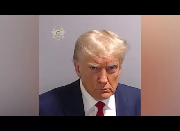 Donald Trump scowling as he stares into the camera for an unexpected mugshot.