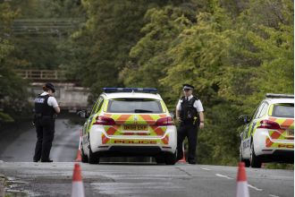Two people drown after driving into flooded road.