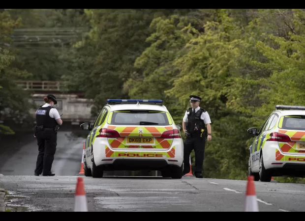 Two people drown after driving into flooded road.