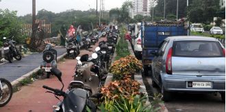 Car dealers encroach service lane, defying the purpose of a cycle track which is now being used as a parking lot in Bhopal.