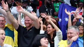 Harry and Meghan show affection as they mingle with spectators at Invictus Games.