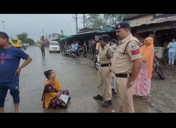 Nurse in Madhya Pradesh protests transfer by sitting on the road in Sehore.