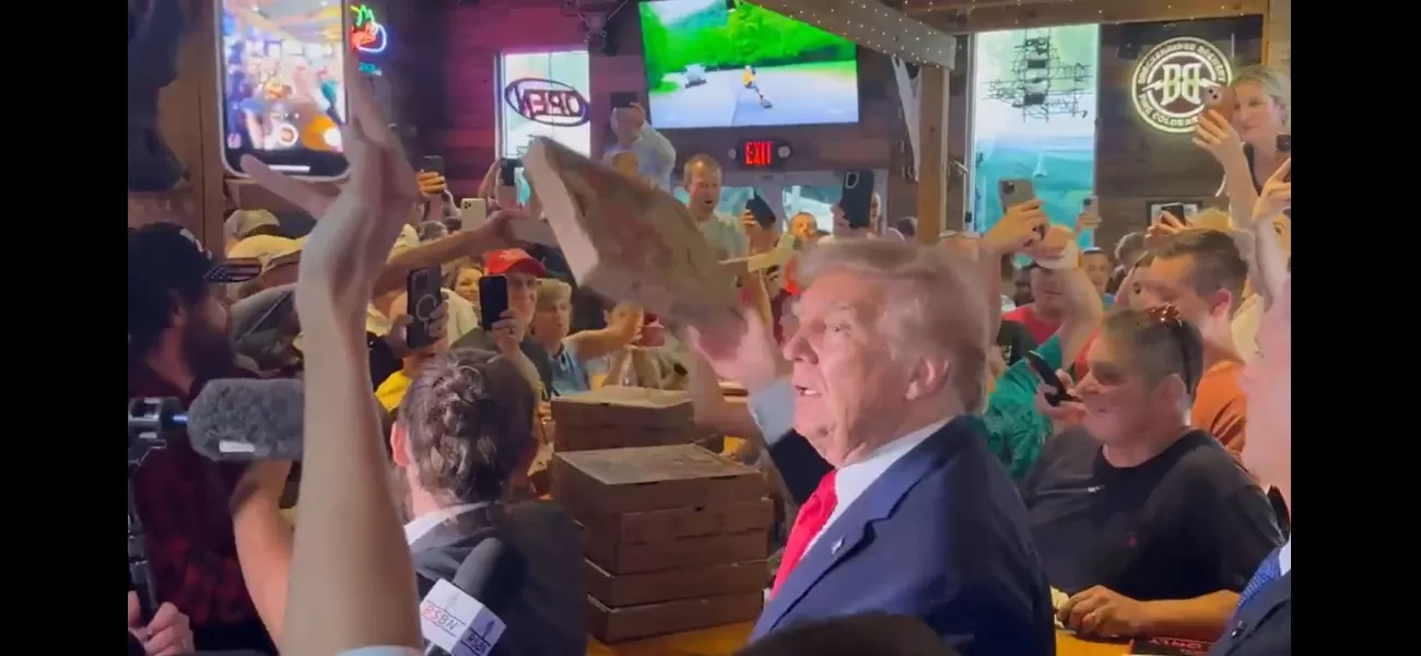 Trump treats supporters to pizza and autographs tops.