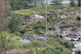 Three people injured after a large sinkhole opened on a motorway.