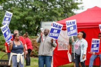 Man yells racist slurs at striking auto workers in Detroit, leading to a brawl.