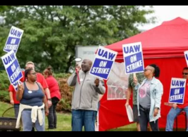 Man yells racist slurs at striking auto workers in Detroit, leading to a brawl.